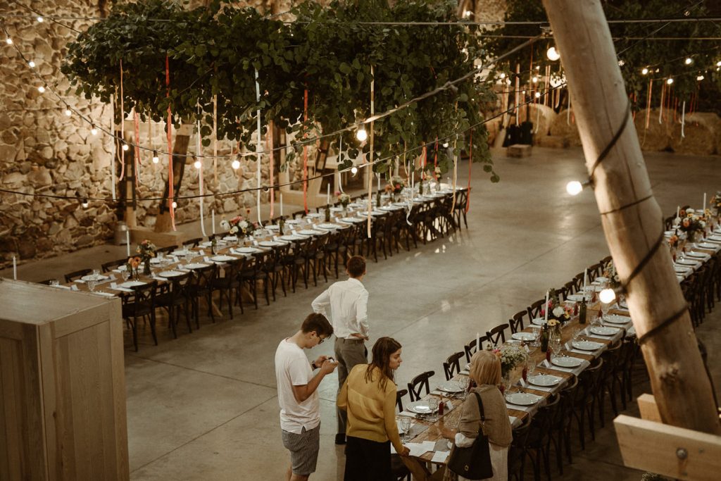 przyjaciele pary młodej pomagają dekorować salę